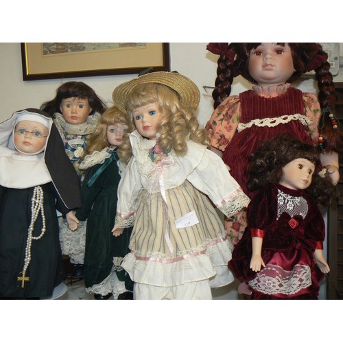 119 - A COLLECTION OF 6 PORCELAIN DOLLS