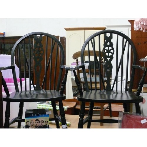 217 - PAIR OF STURDY BLACK PAINTED WHEEL-BACK WINDSOR CHAIRS WITH ARMS.