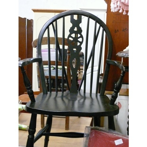 217 - PAIR OF STURDY BLACK PAINTED WHEEL-BACK WINDSOR CHAIRS WITH ARMS.