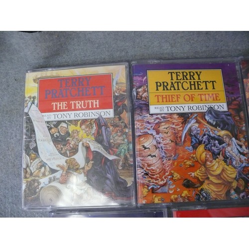 242 - TERRY PRATCHETT TALKING BOOKS. 8 X STORIES EACH WITH 2 CASSETTES. READ BY TONY ROBINSON.