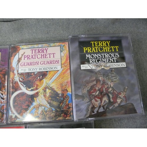 242 - TERRY PRATCHETT TALKING BOOKS. 8 X STORIES EACH WITH 2 CASSETTES. READ BY TONY ROBINSON.