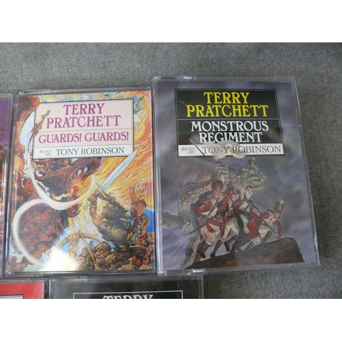 242 - TERRY PRATCHETT TALKING BOOKS. 8 X STORIES EACH WITH 2 CASSETTES. READ BY TONY ROBINSON.