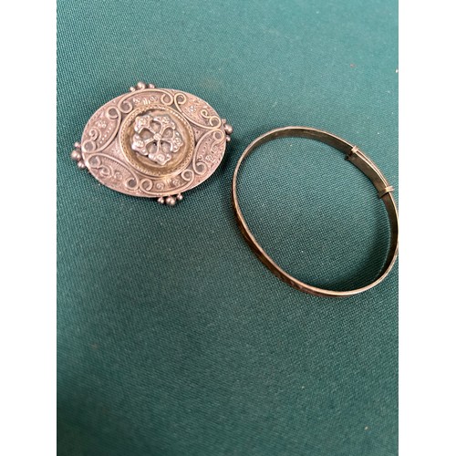 56 - A renaissance style Victorian silver metal locket mourning brooch and a child's silver bangle