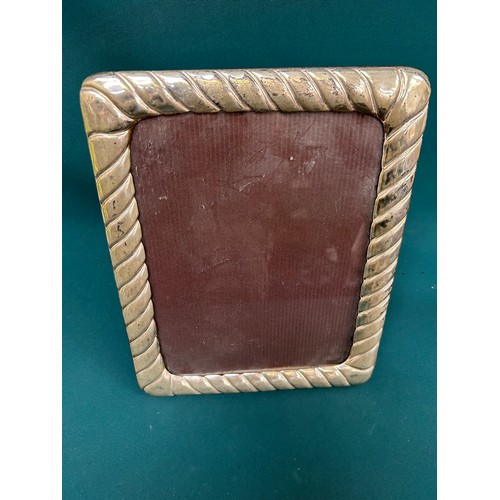 37 - Large silver metal photograph frame in a gadrooned design. Unmarked but label to back 