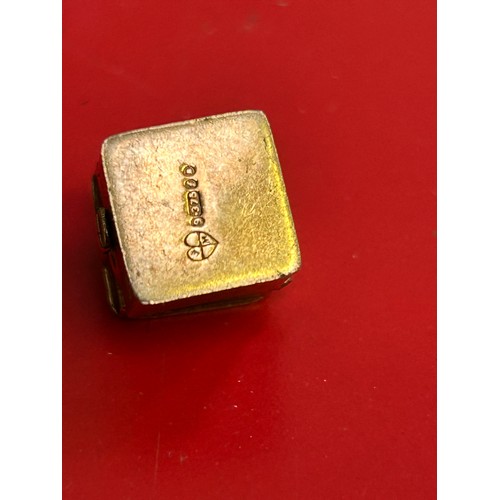 59 - Three 9ct gold charms including a First Aid Box, a sealed £1.00 note and a fob seal with carved blac... 