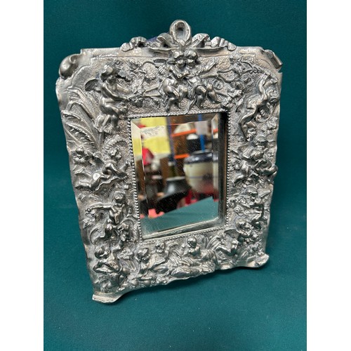 34 - Good quality silver plated dressing table mirror, heavily embossed with cherubs and putti