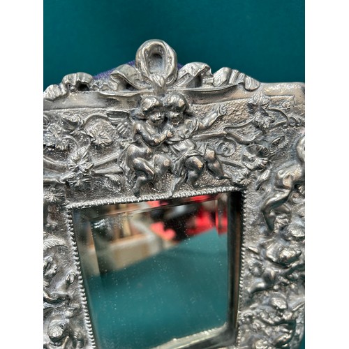 34 - Good quality silver plated dressing table mirror, heavily embossed with cherubs and putti