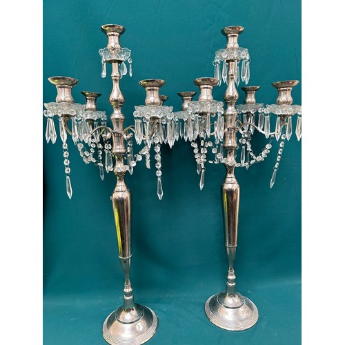 303 - A pair of very tall silver plated candelabra each with four branches and hanging crystals - 42