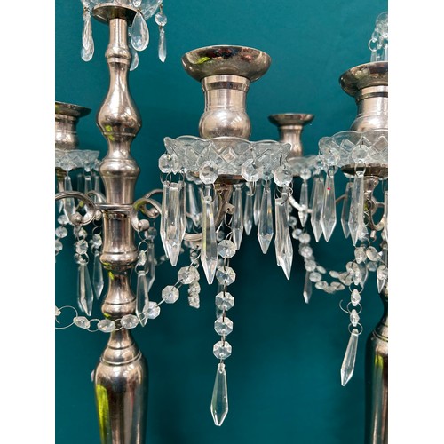 303 - A pair of very tall silver plated candelabra each with four branches and hanging crystals - 42