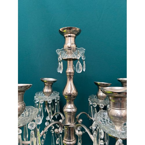 303 - A pair of very tall silver plated candelabra each with four branches and hanging crystals - 42