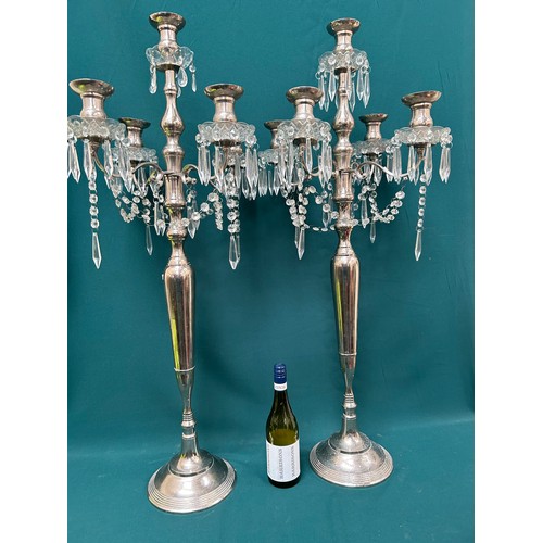 303 - A pair of very tall silver plated candelabra each with four branches and hanging crystals - 42