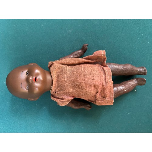 343 - A circa 1930's black doll with composition body & head and moving glass eyes, probably the original ... 