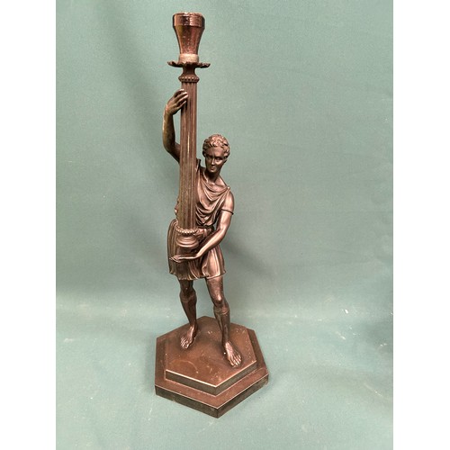 280 - Large metal figural candlestick or lamp base - in the form of a Grecian holding a torch. 57cm