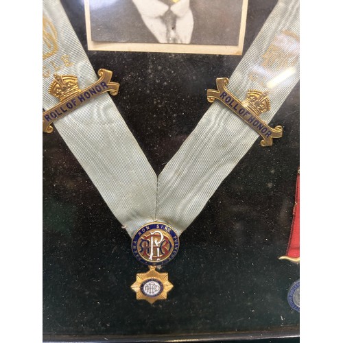 121 - A framed collection of 1930's & 40's  Royal Antediluvian Order of Buffaloes medals and jewels, with ... 