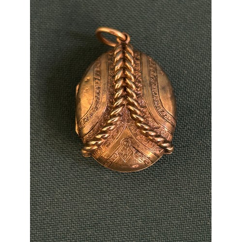 45 - Victorian gilt metal locket with a rope design and marked with a diamond registration mark for 1867