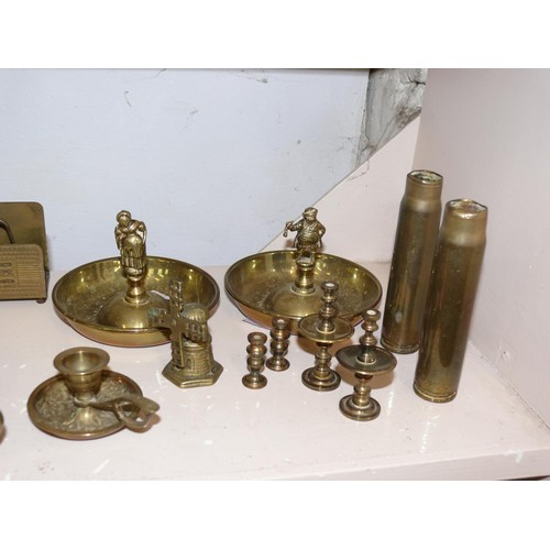 84 - COLLECTION OF BRASS ITEMS TO INCLUDE  HORSE BRASSES ON LEATHERS, CANDLESTICKS, SHELL CASES ETC