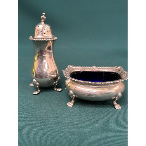 26 - Sterling silver matched pepper pot and salt with blue glass liner, Birmingham 1951 & 1960. Silver we... 