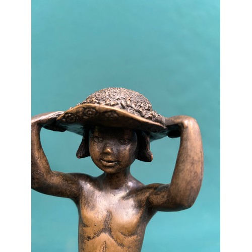 92A - LAUGHING BUDDHA FIGURE AND A BRONZE RESIN FIGURE OF A LITTLE GIRL WITH A BIG HAT - 20CM H