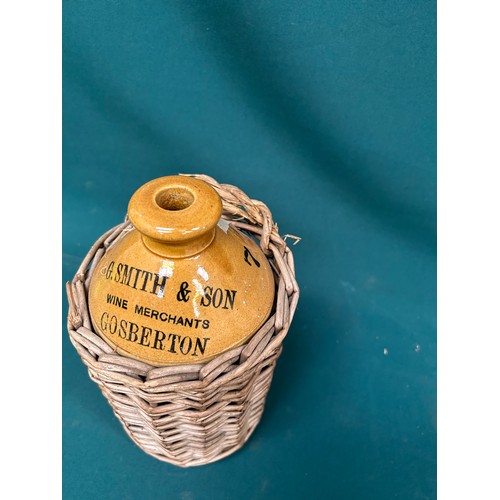 388 - A small stoneware beer or wine flagon in original wicker carrier for G Smith & Son, Wine Merchants, ... 