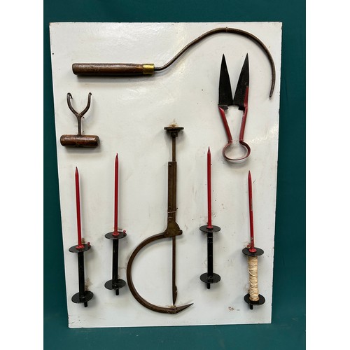 377 - Display board with collection of vintage roof thatcher's tools to include a ridge needle, hooks etc