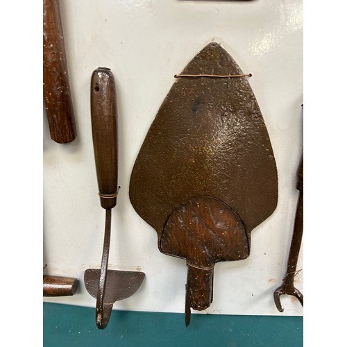 378 - Display board with collection of antique & vintage Gardener's tools to include trowel, hand hoe, boo... 