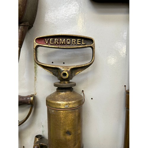 380 - Display board with collection of antique & vintage oil cans, sprayers, stirrup pump, WW1 Shand Mason... 