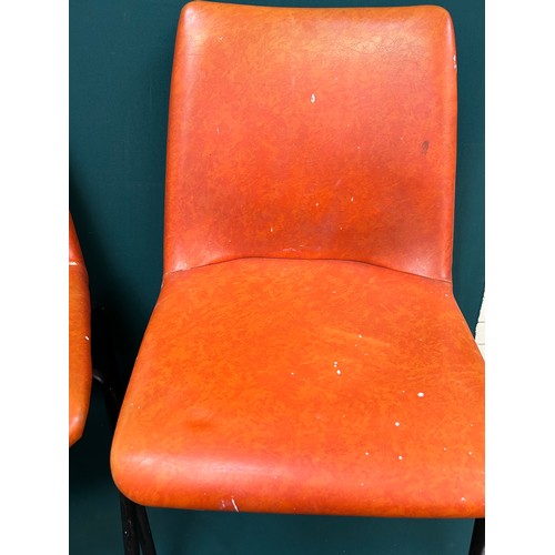 491 - Set of four 1970's stacking chairs upholstered in original burnt orange vinyl fabric - one has paint... 