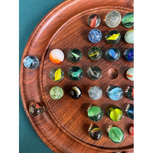 186 - A turned walnut solitaire board with collection of vintage & antique glass marbles