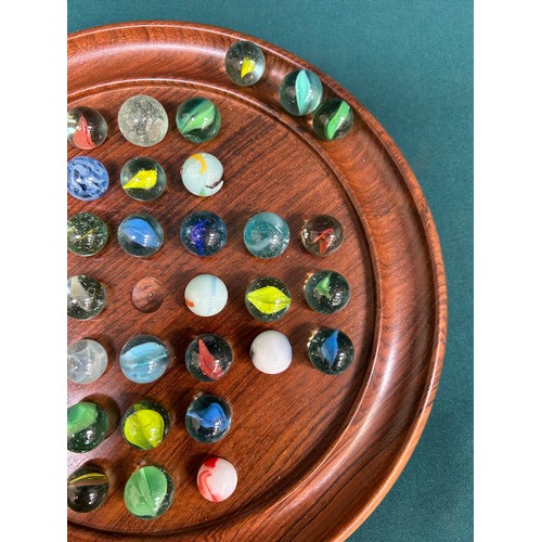 186 - A turned walnut solitaire board with collection of vintage & antique glass marbles