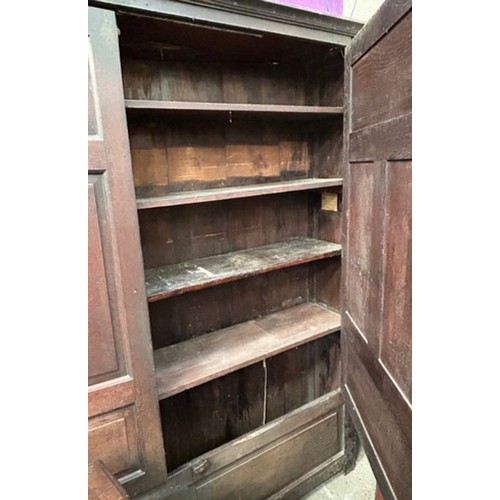 521 - A very large antique oak Housekeepers cupboard from a Norfolk country house. The doors each with fou... 