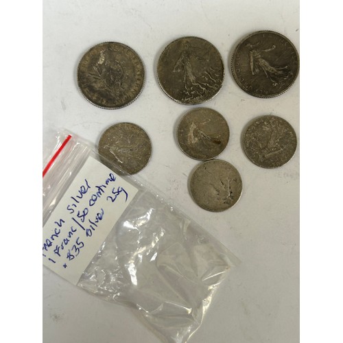 93 - Bag of Foreign coins including Jersey, Ireland, Italy, USA, Guernsey, French. Includes French .835 s... 