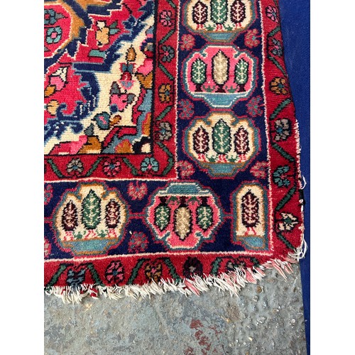 287 - Large Vintage Persian Hamadan carpet with central medallion in reds and blue against a paler field. ... 