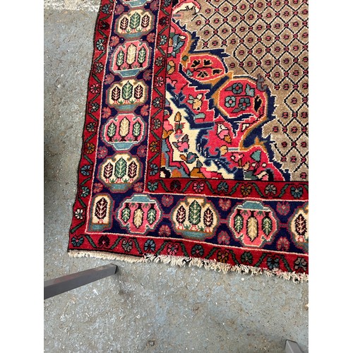 287 - Large Vintage Persian Hamadan carpet with central medallion in reds and blue against a paler field. ... 