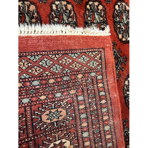 288 - Large 20th Century Bokhara hand knotted carpet in russet, sand and pale blue colours. 150cm x 250cm