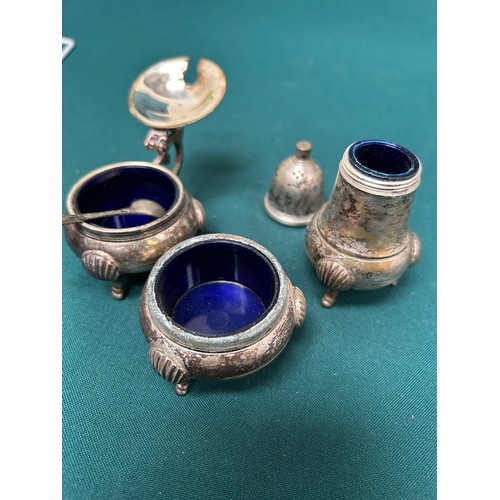 289 - A Victorian part condiment set on plated stand and a 3 piece set with blue glass liners - losses and... 