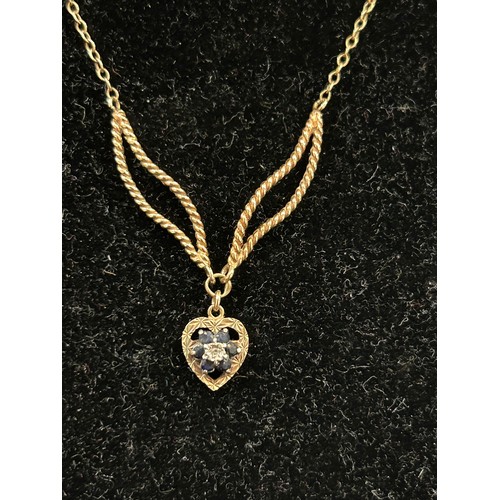 39 - A 9CT GOLD NECKLACE WITH SAPPHIRE HEART PENDANT - UNUSUAL DOUBLE LEAF DESIGN FOR THE PENDANT FITTING... 