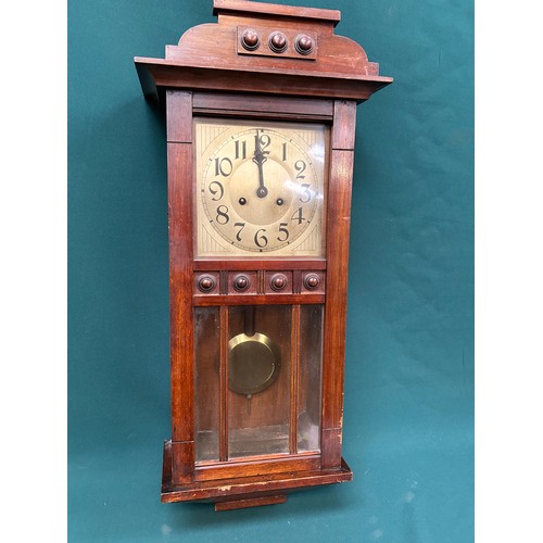 275 - A 1920's wall clock with Art Deco style face, in a mahogany case, by Badische Germany, with pendulum... 