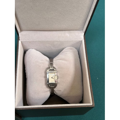 69A - A stylish Gucci ladies wrist watch with original box and booklet. Recently serviced & working