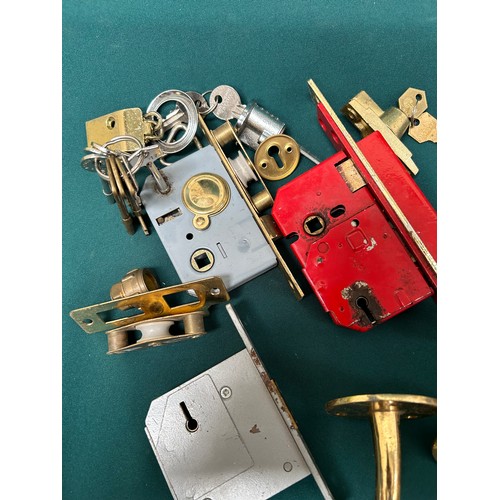 334 - Brass ware including door furniture - locks, letter box etc a hinged coat hook, brackets etc