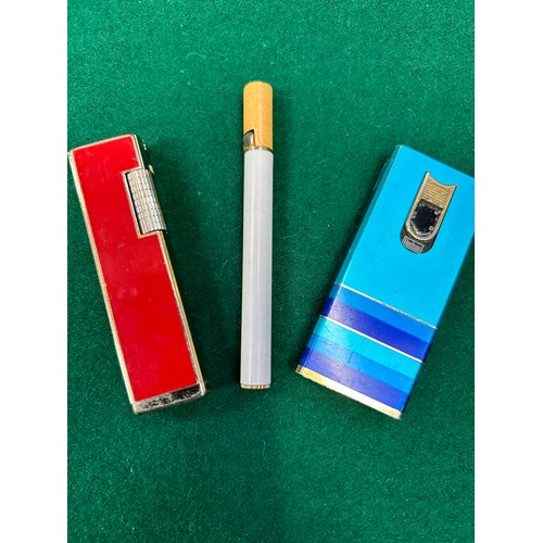 117D - Three retro cigarette lighters to include one in the shape of a cigarette, a Hudson 3000 and a Mento... 