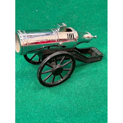 113 - A chrome and black metal cannon cigarette lighter marked “Modern”