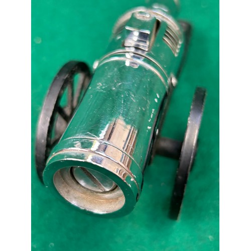 113 - A chrome and black metal cannon cigarette lighter marked “Modern”