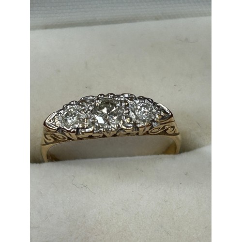 41A - A beautiful 18ct Gold trilogy ring set with a 3mm white round cut diamond flanked by two white round... 