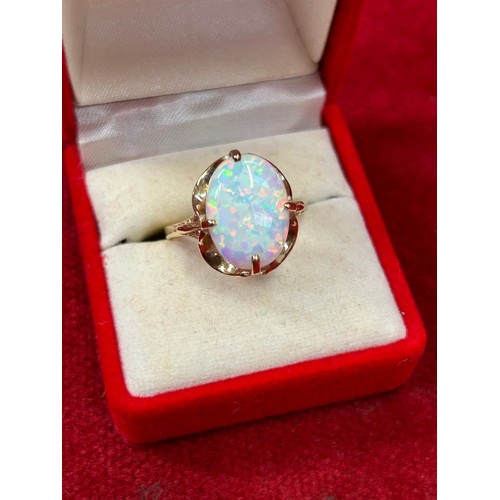 41C - A 9ct Gold ring with large white opal stone (15mm x 10mm),  sparkling iridescent colours, elegant cl... 