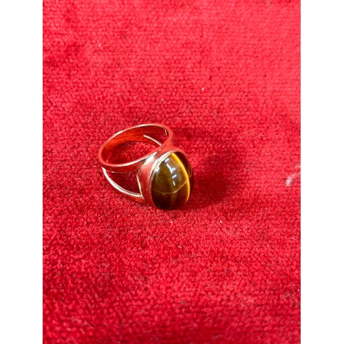 41D - Modernist style 9ct gold ring with large oval Tigers Eye stone (20mm X 15mm), gross weight 8.8 grams... 