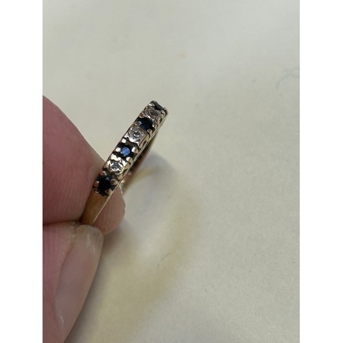 50D - 9ct Gold half eternity ring set with 3 diamonds and 4 sapphires raised on a pierced gallery spelling... 