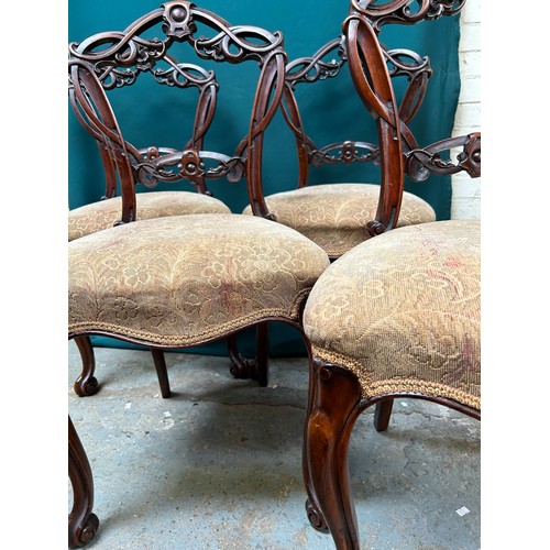 427 - Set of four Victorian dining chairs with ornately carved backs, on cabriole legs. One needs back leg... 