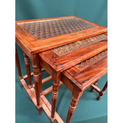 428 - Unusual nest of three tables in rosewood with brass leaf inlay, the tops pierced in a geometric desi... 