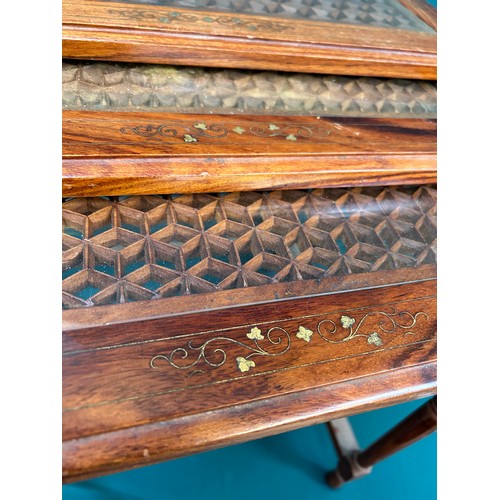 428 - Unusual nest of three tables in rosewood with brass leaf inlay, the tops pierced in a geometric desi... 