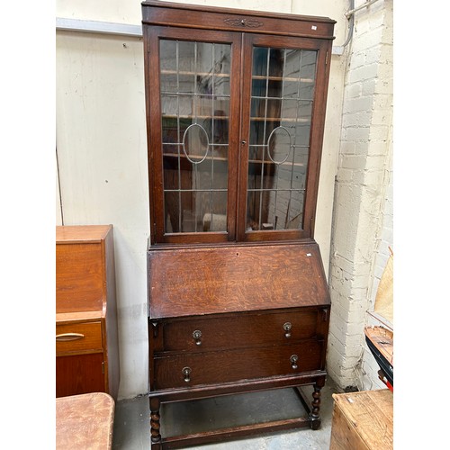 422 - 1920’s oak bureau bookcase on barleytwist legs, leaded glass to doors